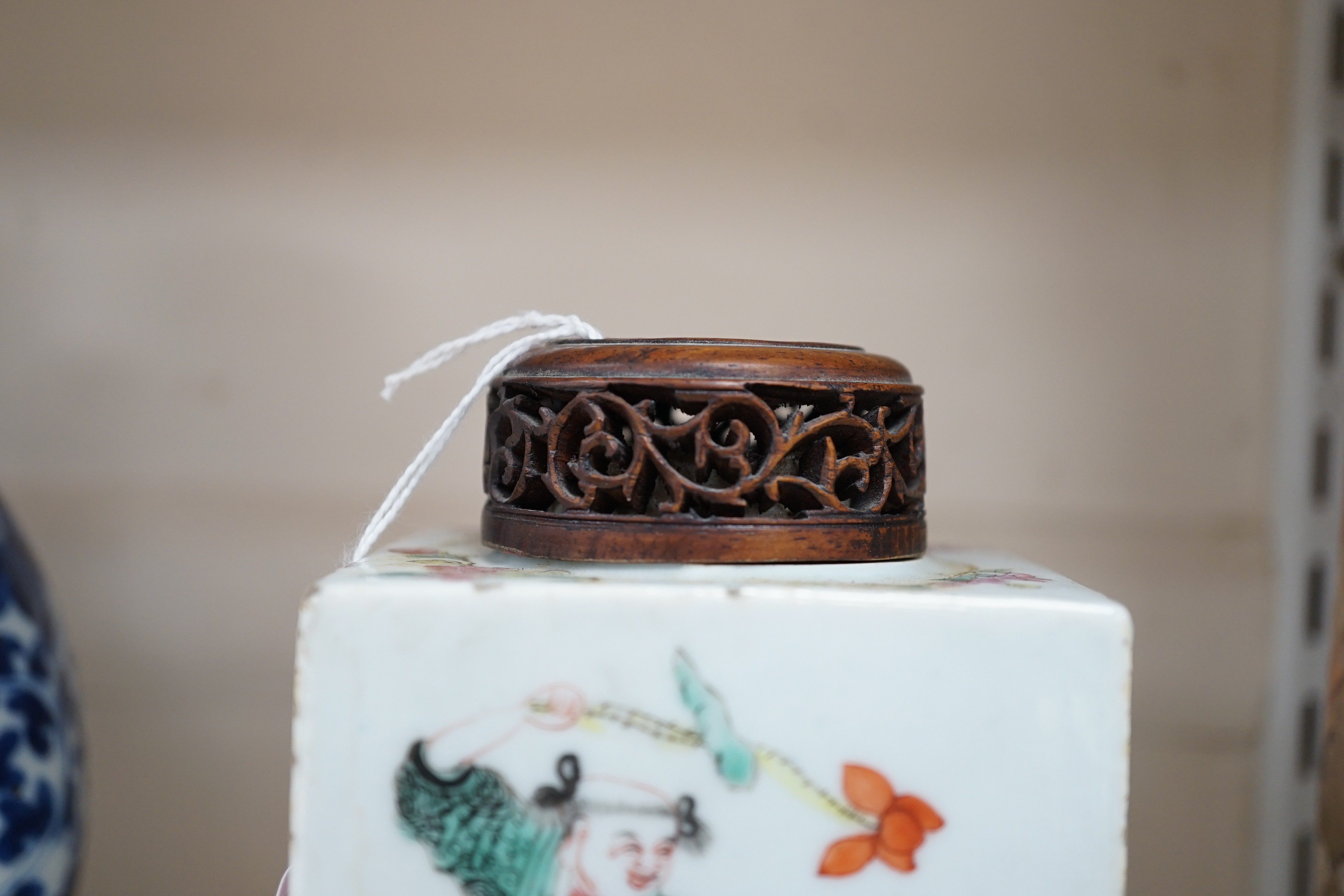 A Chinese famille rose square tea caddy, mid 19th century, 13.7cm high excluding wood stand and cover, slight damage